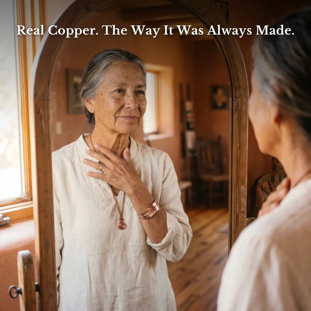 Woman wearing handcrafted copper jewelry in a mirror